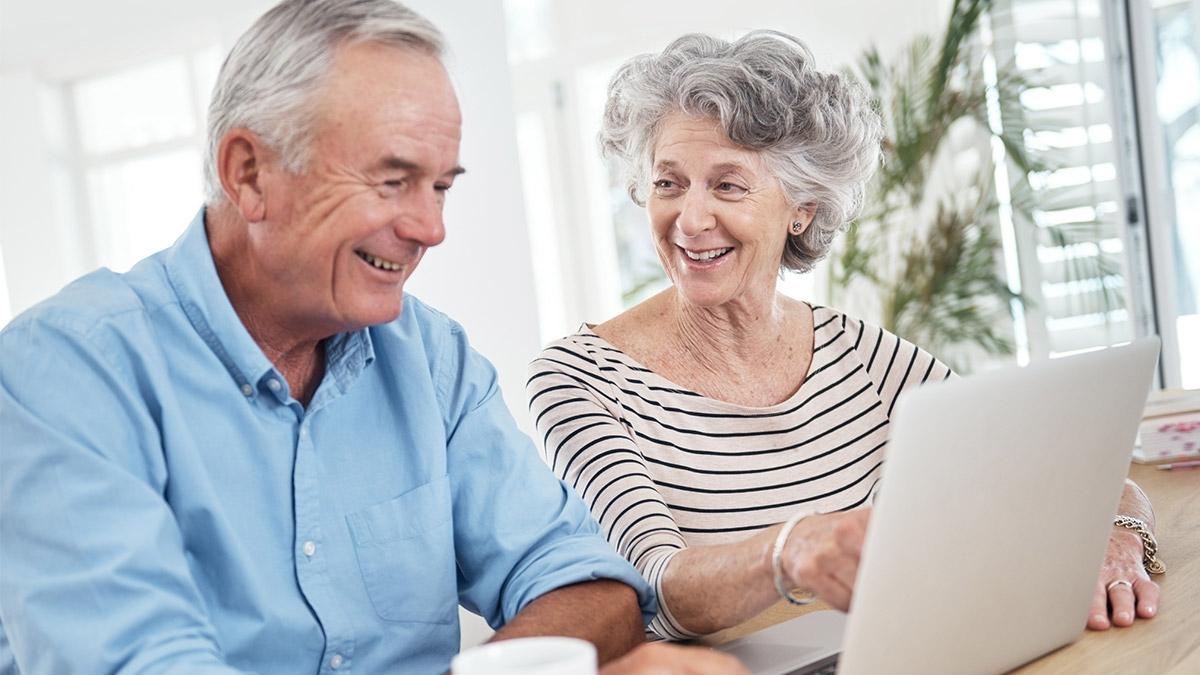Senior couple looking at laptop