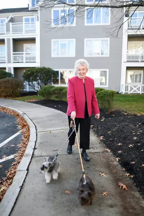 Senior woman walking dogs