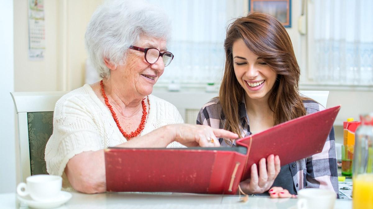 Grandmother and granddaughter looking at photos