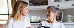 Adult daughter and senior mother speaking