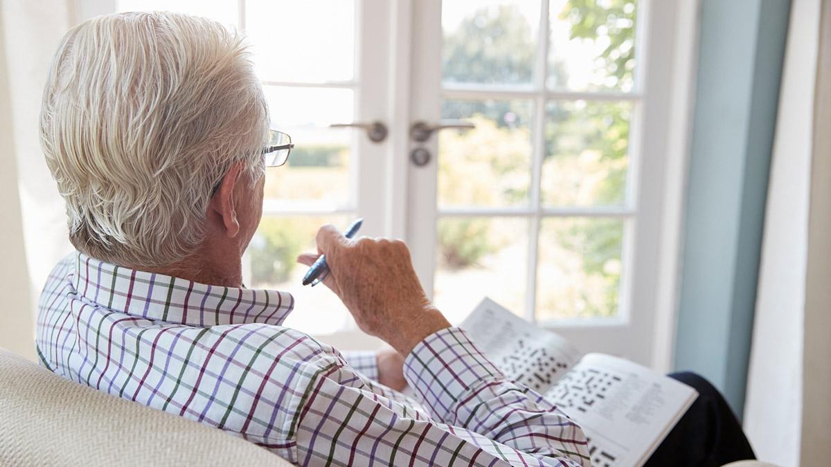 Senior man doing crossword puzzle