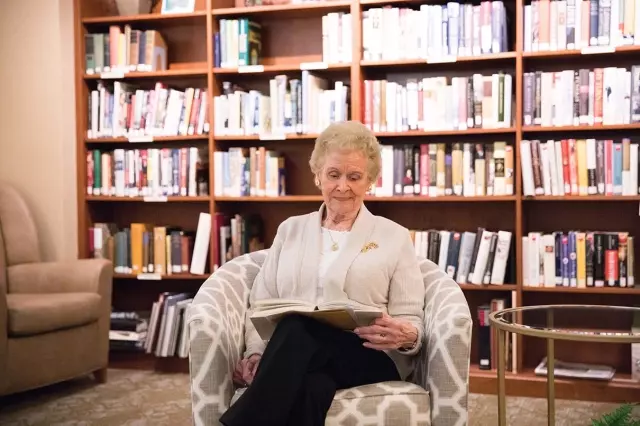 Senior woman reading in library