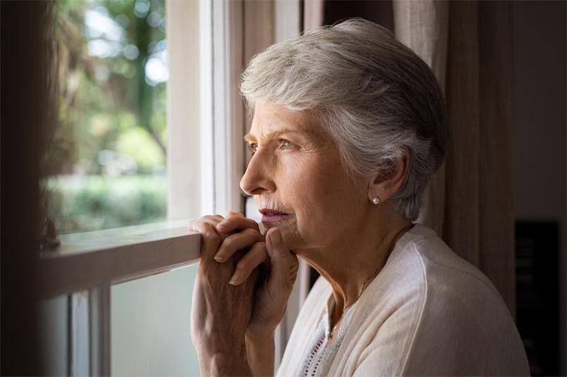 Senior woman looking out of window