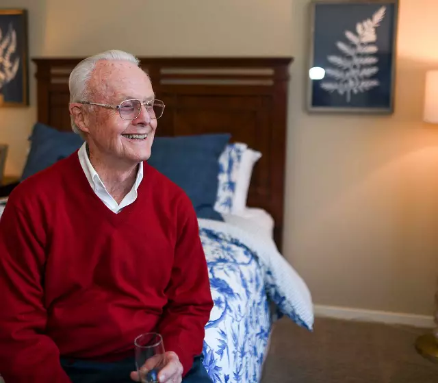 Senior man sitting on bed