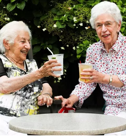 Senior women having drinks outdoors