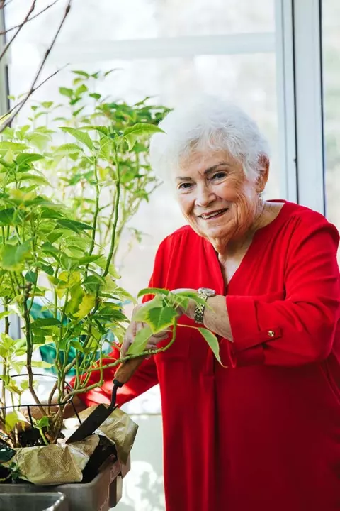 Senior woman with plants
