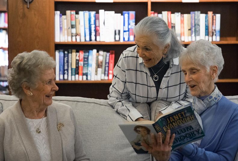 Interior library resident women reading books